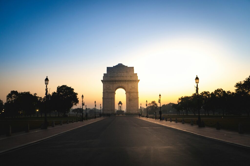 Serene view of the India Gate in New Delhi at dawn, highlighting its architectural beauty and historical significance.